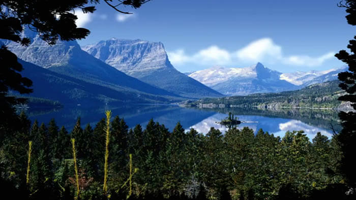 an american landscape with a lake and mountains